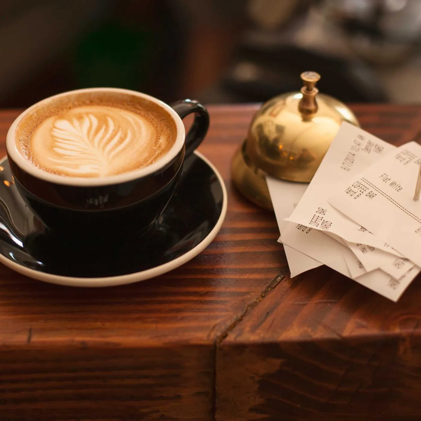 Latte art in a ceramic cup on a wooden table