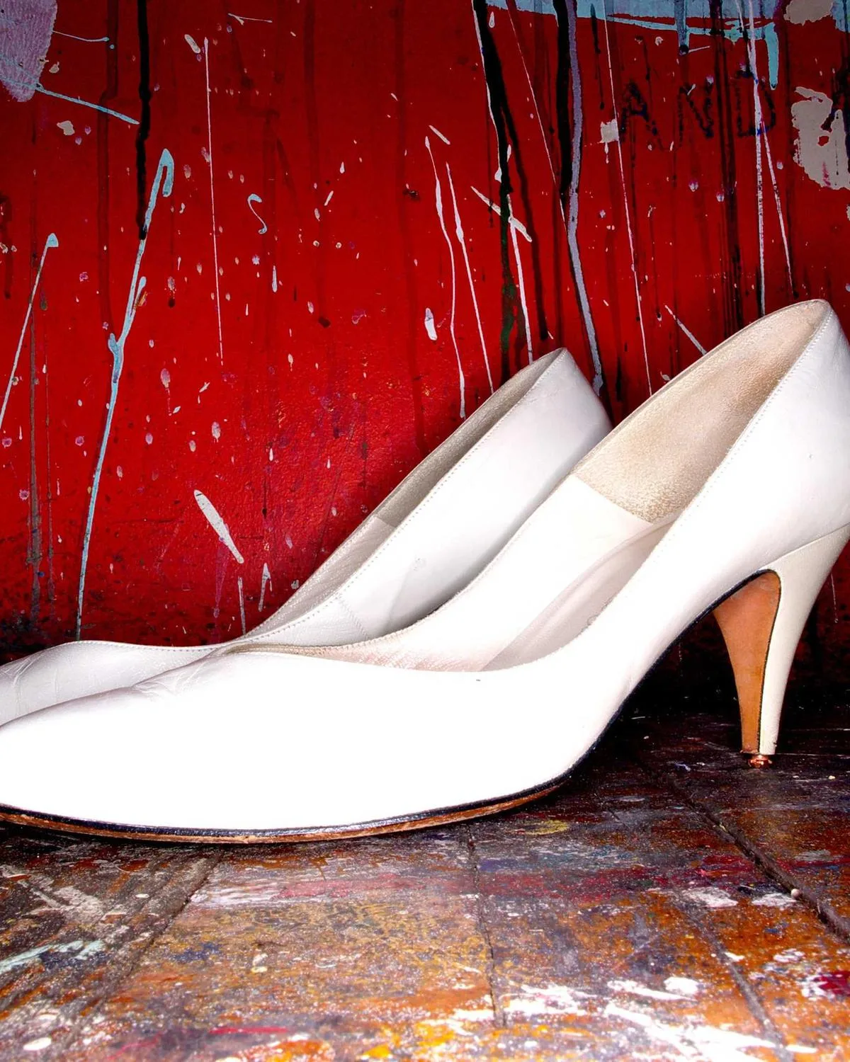 White heels on a red painted floor