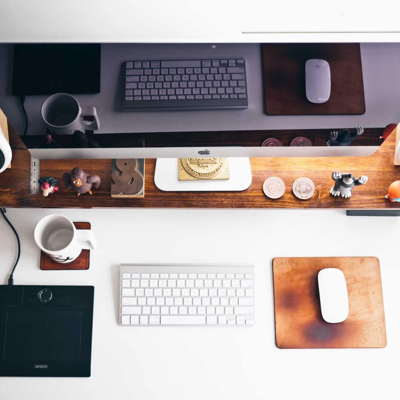 Tidy creator desk with keyboard, notebook and coffee