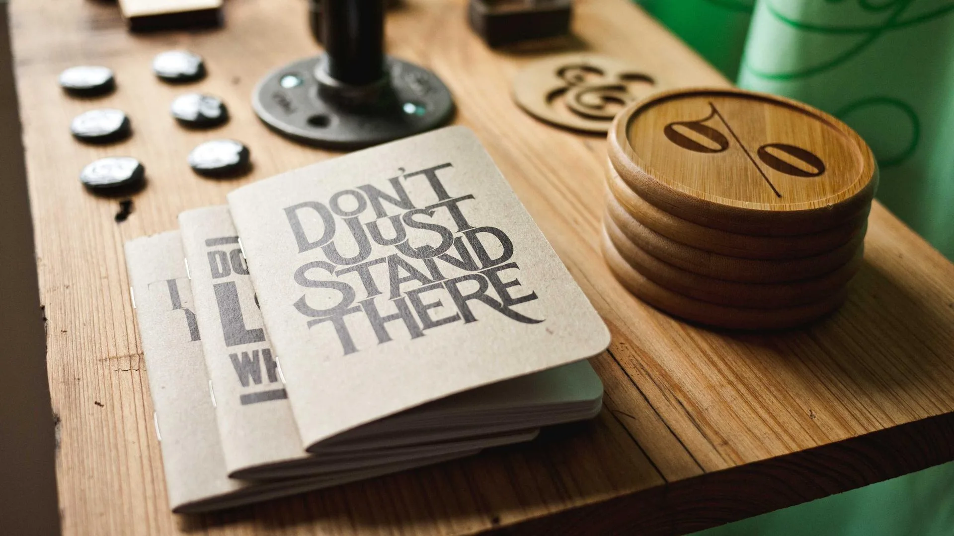 Hand-lettered book cover on a wooden desk