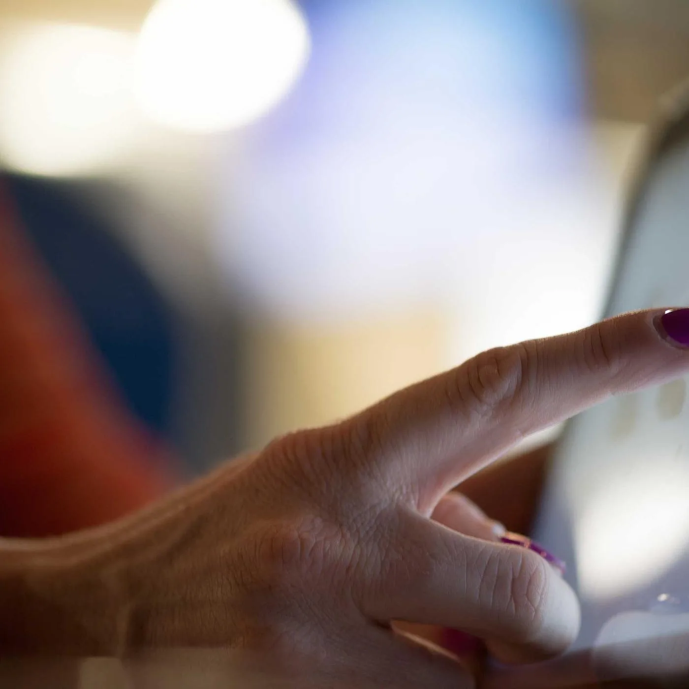 Hand holding a phone, mid-scroll