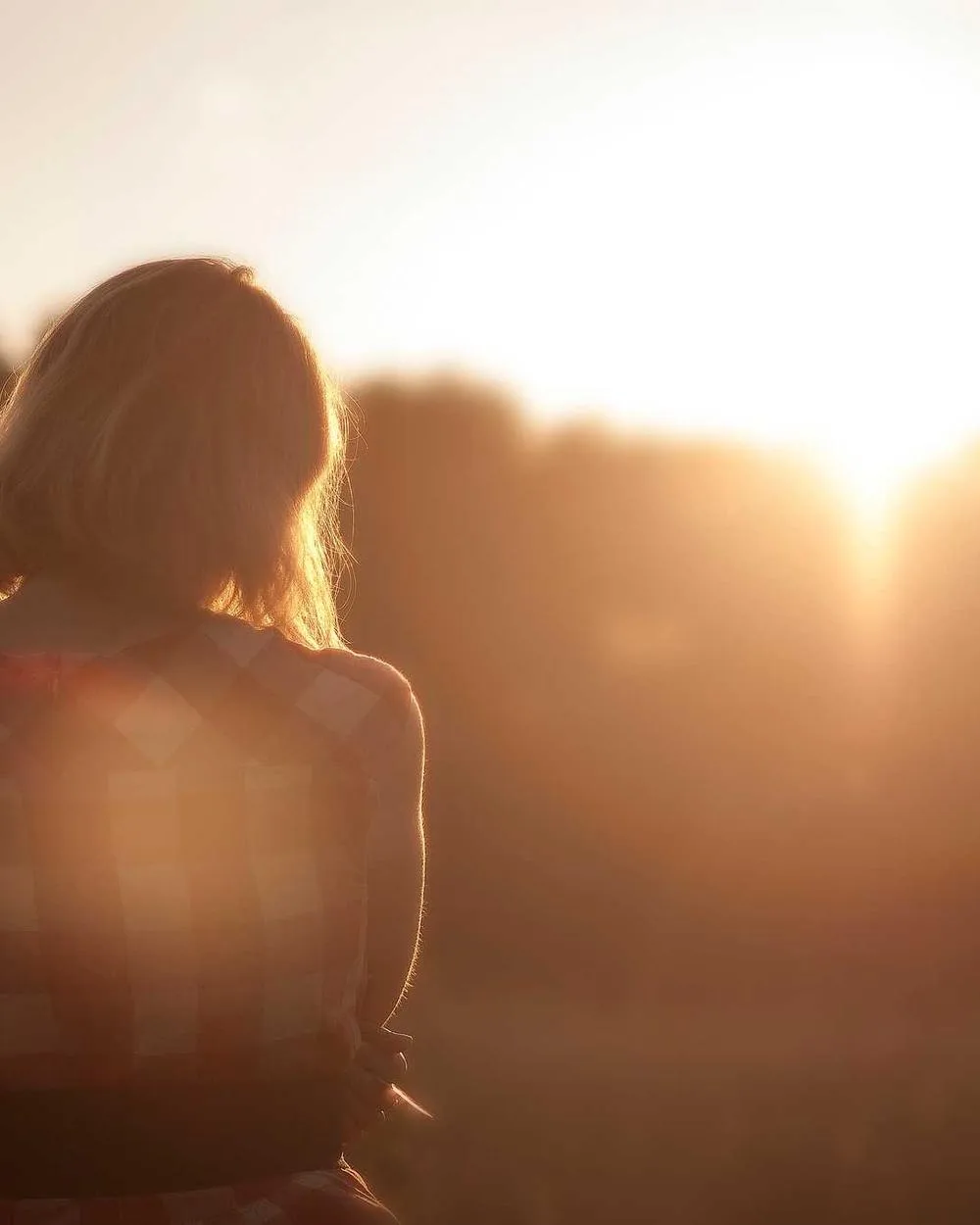 Creator silhouetted against low sunlight