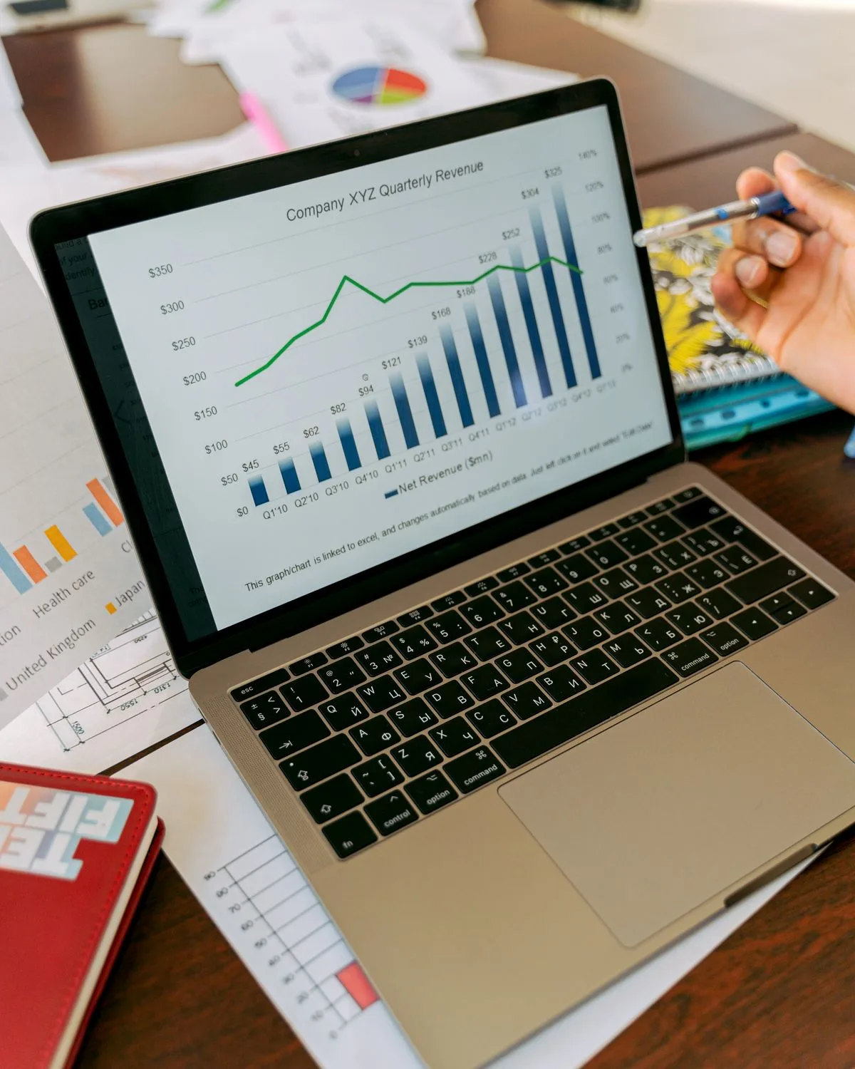 Laptop showing a revenue chart climbing quarter on quarter